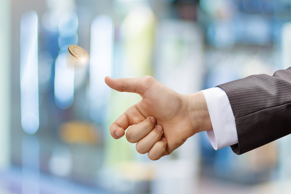 Businessman tosses a coin